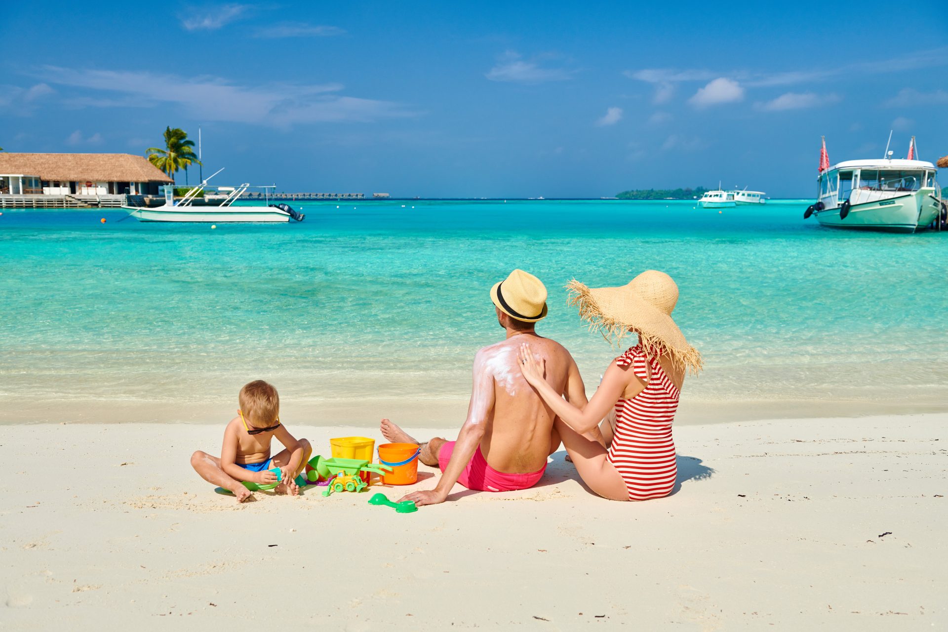 Family with three year old boy on beach