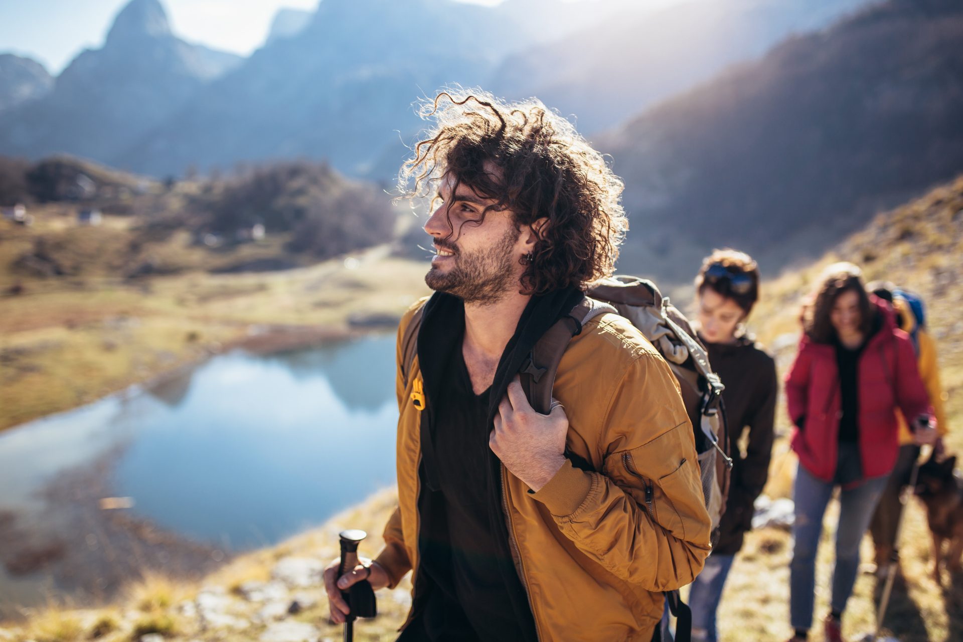 Group of hikers walking on a mountain at autumn day